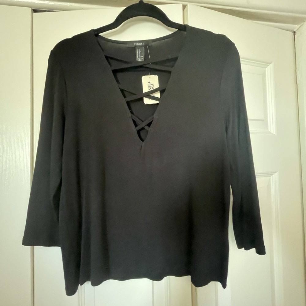 Black knit top with cross cross detail at neckline